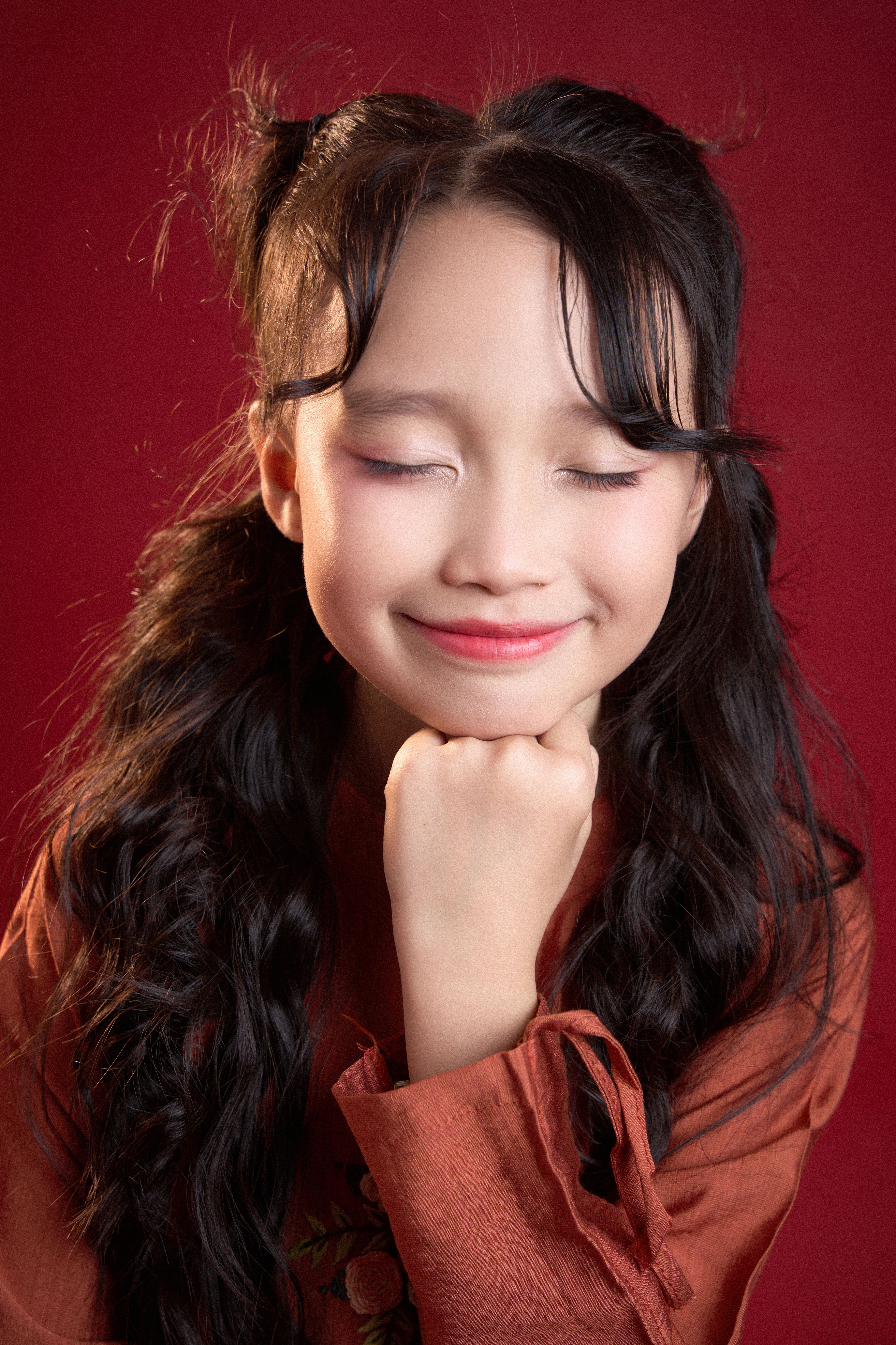 Smiling girl with her eyes closed